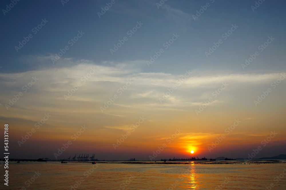 Sunset sky at sea with silhouette of island background Sunset sky at sea with silhouette of island background