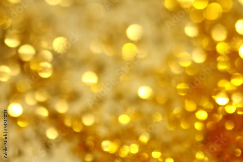 Abstract background of small bokeh with golden sparkles.