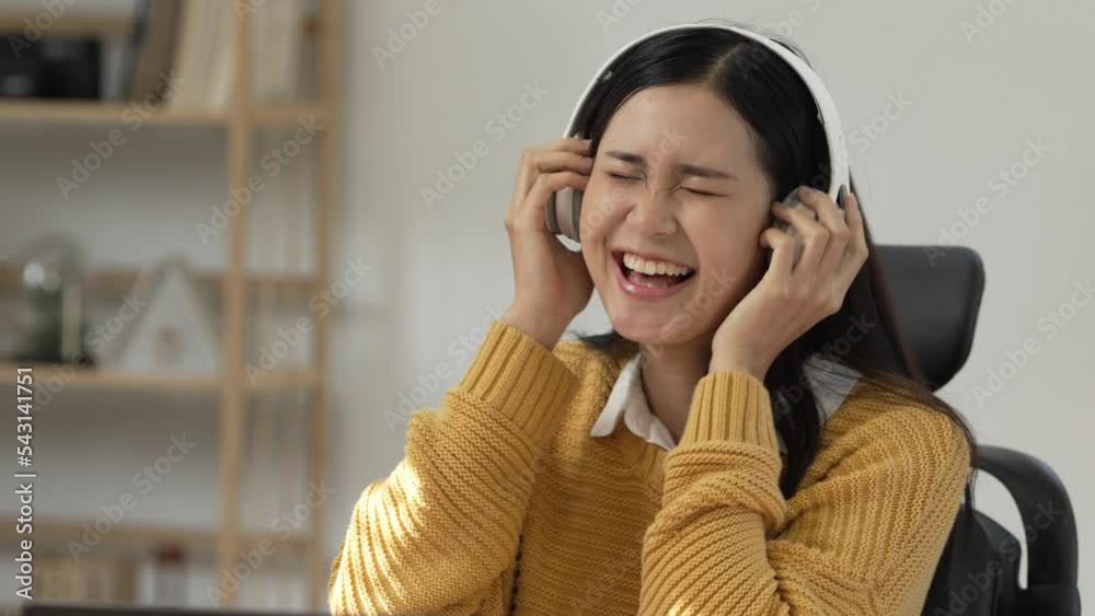 Beautiful asian woman in sportswear put on headphone listening music relax after workout. Beautiful asian woman in sportswear put on headphone listening music relax after workout.