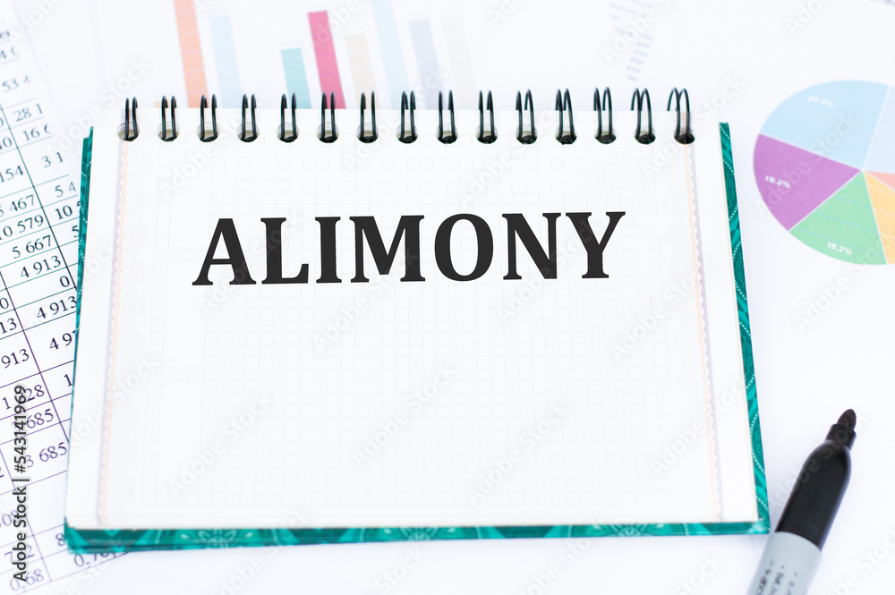 Alimony inscription on a notebook on an office desk, a business concept Alimony inscription on a notebook on an office desk, a business concept