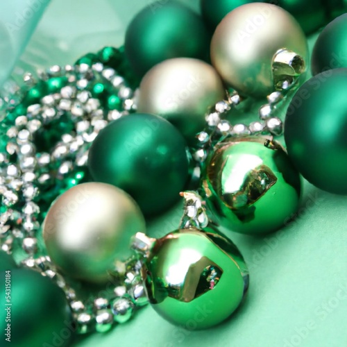Green  gold and silver christmas tree decorations with baubles and ornamental string