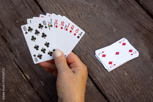 A handful of playing cards, to play the favorite game of belote, with four people, photo taken in the USA