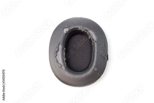 broken headphone pad from frequent use isolated on a white background. photo