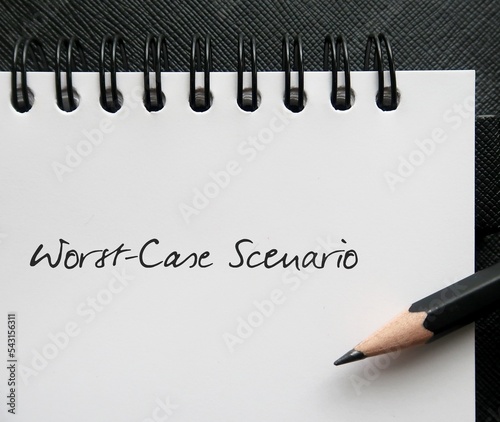 Pencil writing on notebook WORST-CASE SCENARIO, means preparing for most unpleasant or serious thing that could happen in a situation, and plan solutions if it happens photo