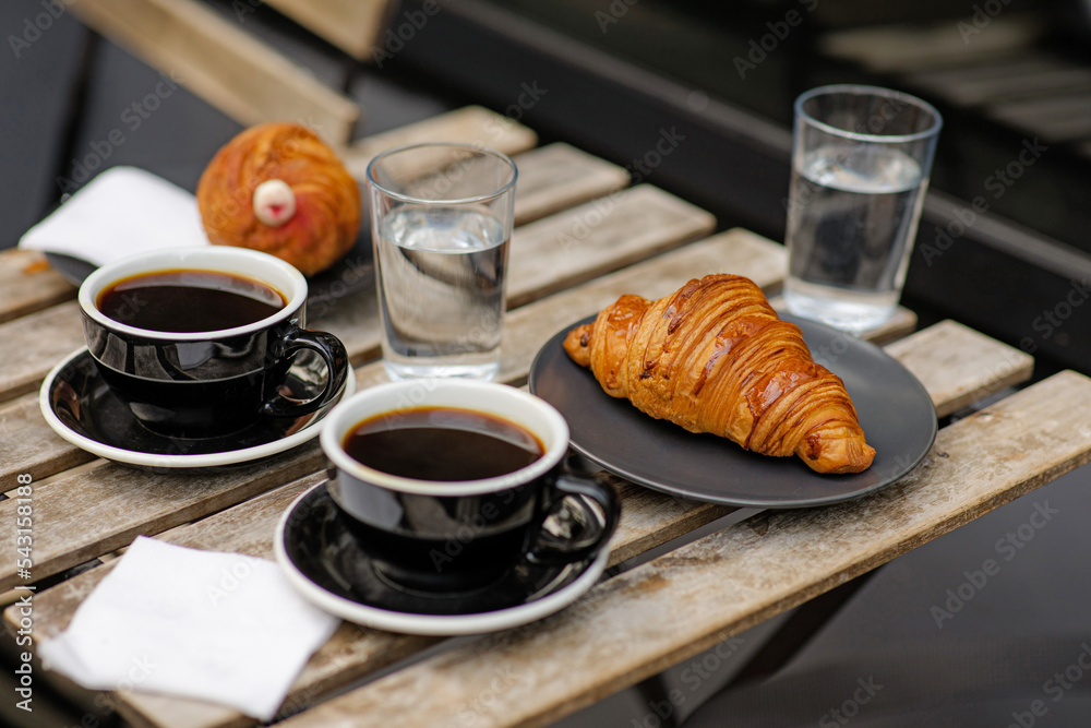 Air croissants with black coffee. Delicious desserts. Aromatic coffee outside. Break to meet a girlfriend. Coffee for two