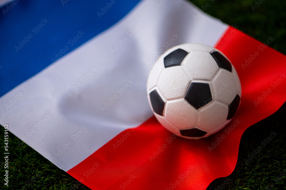 France national football team. National Flag on green grass and soccer ball. Football wallpaper for Championship and Tournament in 2022. World international match. France national football team. National Flag on green grass and soccer ball. Football wallpaper for Championship and Tournament in 2022. World international match.