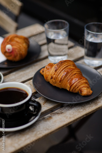 Air croissants with black coffee. Delicious desserts. Aromatic coffee outside. Break to meet a girlfriend. Coffee for two