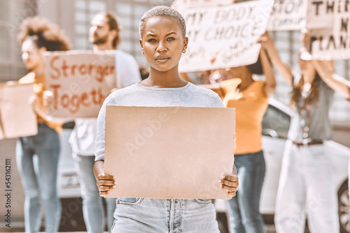 Protest, sign and mockup with a black woman activist holding cardboard during a rally or demonstration. Poster, freedom and politics with a young female fighting for human rights or equality © C D/peopleimages.com