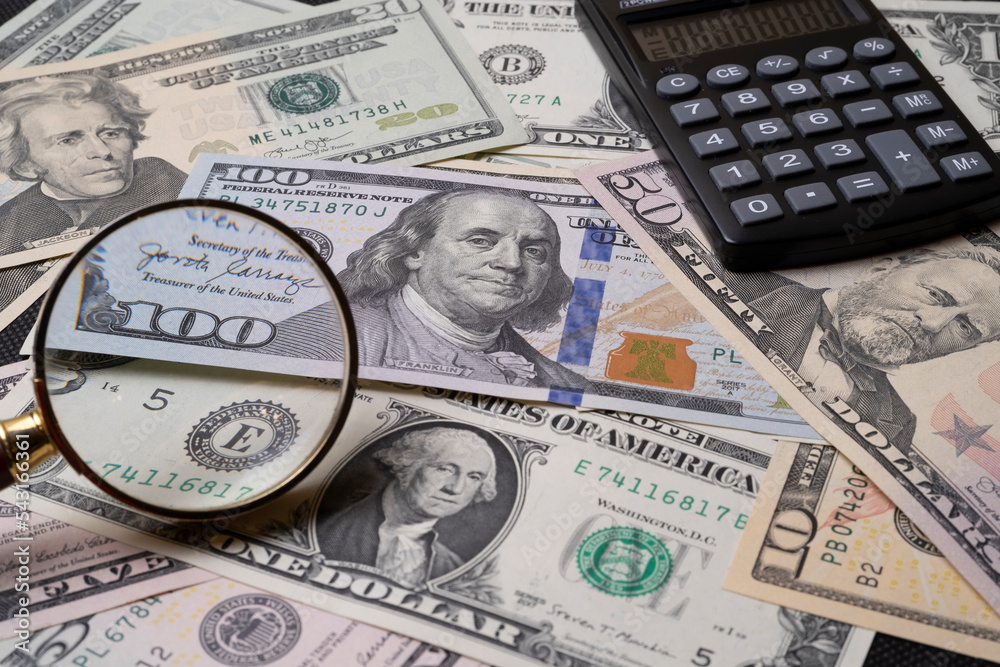 US dollar 100 cash, close up, canculator magnifier US dollar 100 cash, close up, canculator magnifier