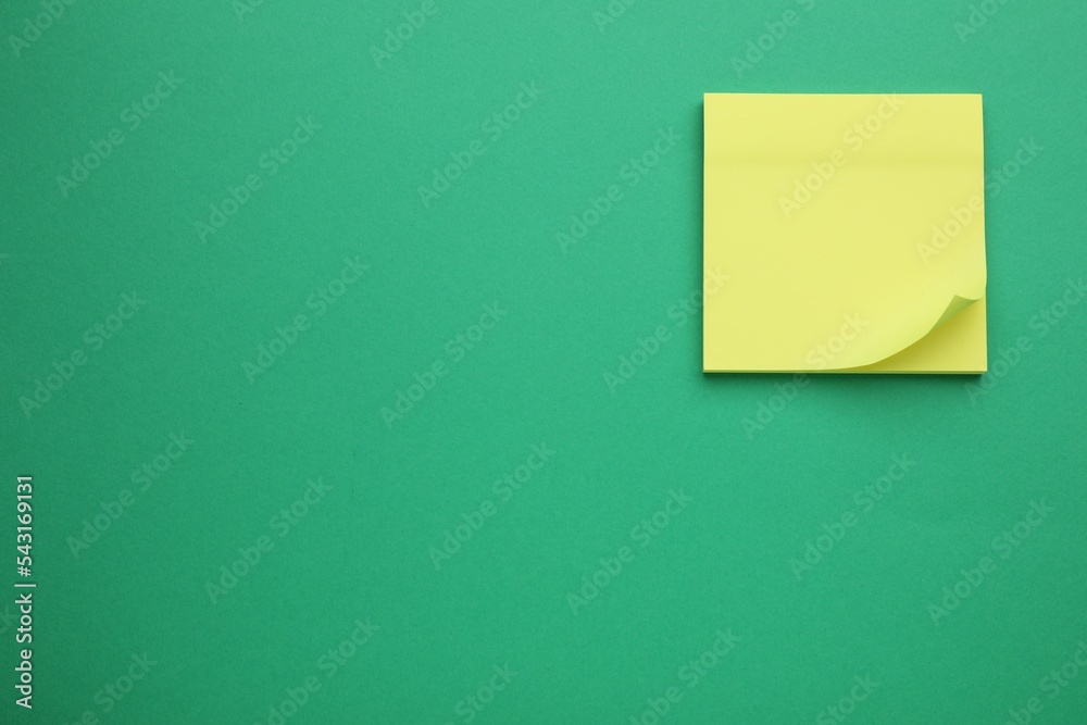 Empty notes on green background, top view. Space for text Empty notes on green background, top view. Space for text