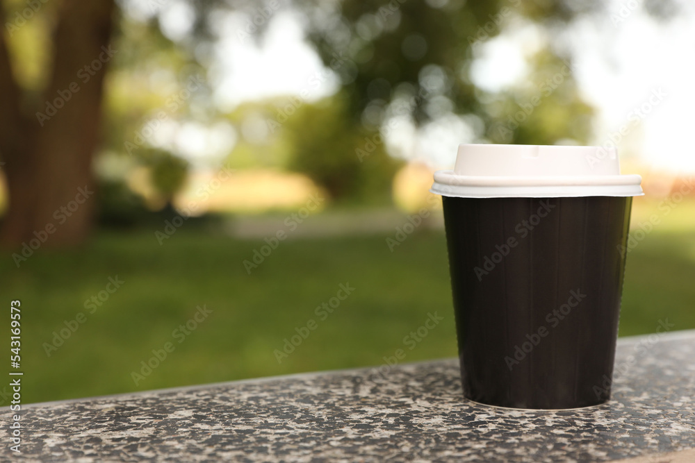 Paper cup on parapet in park, space for text. Coffee to go Stock Photo ...