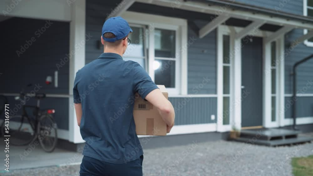 Portrait of a Handsome Young Homeowner Receiving an Awaited Parcel from a Cheerful Mailman. Postal Service Worker Comes to the House to Make a Door to Door Delivery and Get a POD Signature on Tablet.