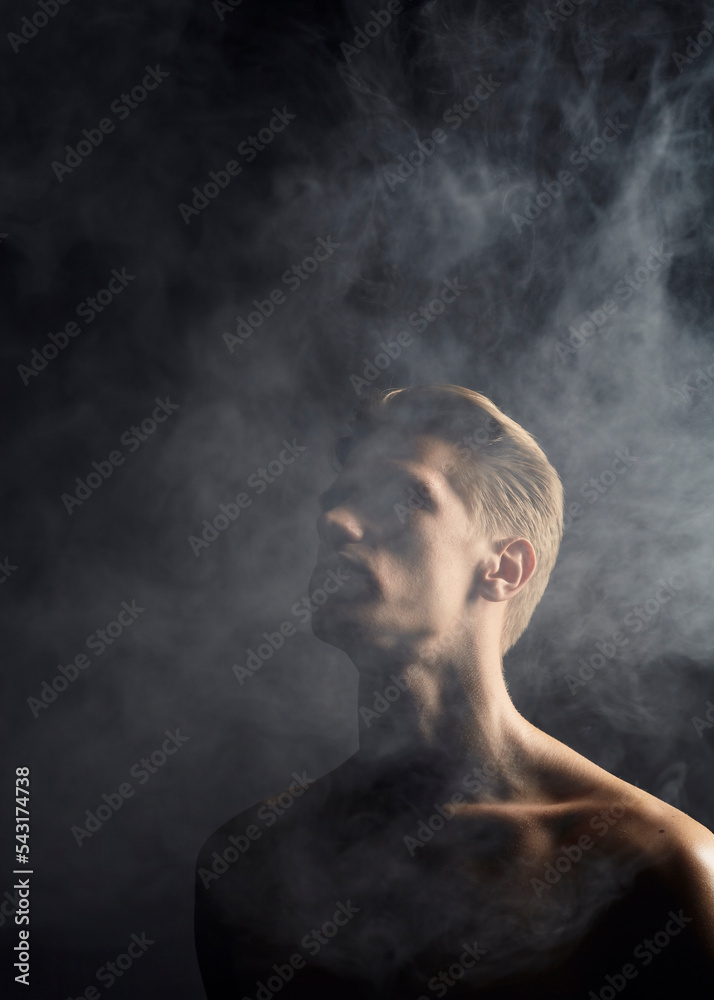 portrait of a smoking man on a black background. Topics of negative habits and bad effects on the body portrait of a smoking man on a black background. Topics of negative habits and bad effects on the body