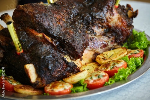 Serving meat dishes in the restaurant, baked pork ribs with vegetables.