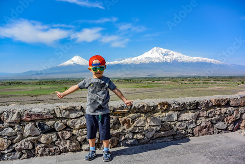 Little boy on the background of a beautiful view of mount Ararat in the afternoon. May 6, 2019. Armenia.