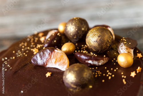 New Year's Eve chocolate cake decorated with gold chocolate balls