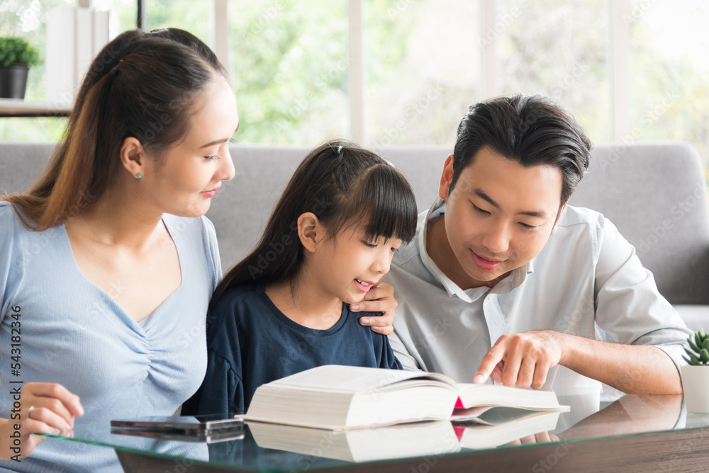 Happy family sitting together and help teaching daughter about her homework in living room. Happy family sitting together and help teaching daughter about her homework in living room.