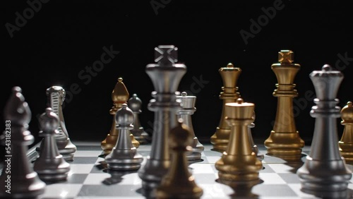 Angry hand of a losing chess player wiping pieces off the board. photo