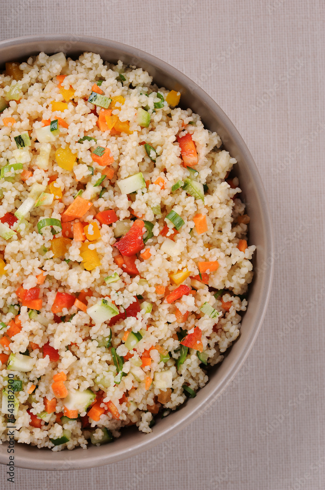 Couscous with vegetables in a rustic bowl. Moroccan couscous. Top view Couscous with vegetables in a rustic bowl. Moroccan couscous. Top view