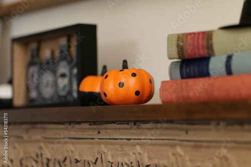 Closeup shot of a spotted orange mini pumpkin decoration on a shelf