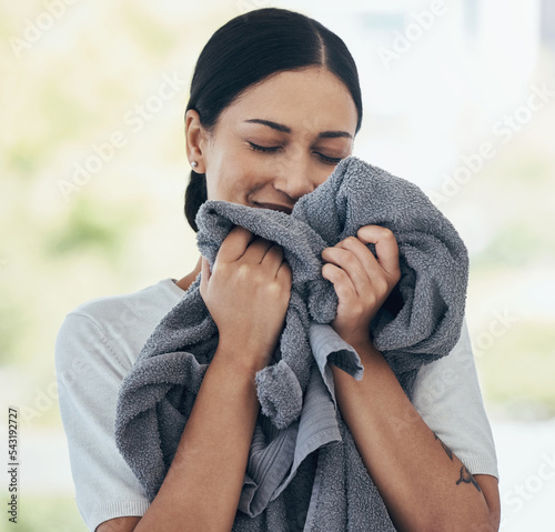 Clean laundry, happy woman and smelling towel, fresh scent and fabric, washing and linen textile at home. Young smile person, housekeeping service and domestic cleaning lifestyle photo