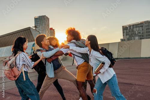 Cheerful students playfight outside. photo