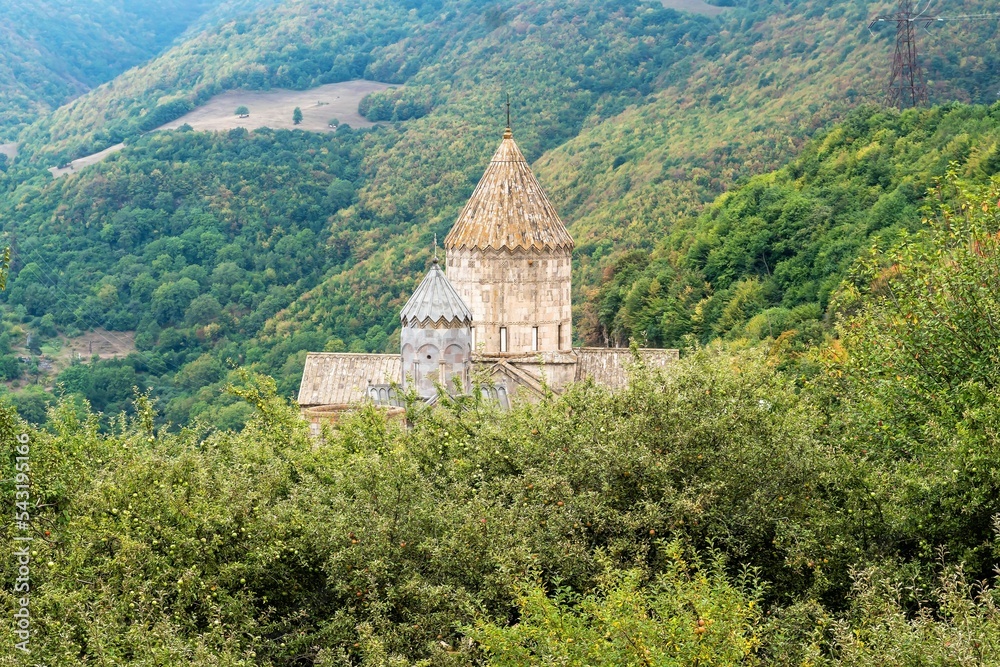 Armenia, Tatev, September 2022. Armenian temple among the apple orchard.