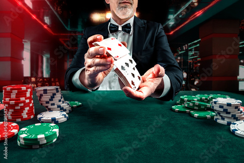 Leinwand Poster Croupier or casino dealer at gambling club or casino