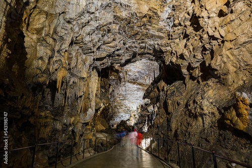 Under the ground. Beautiful view of stalactites and stalagmites in an underground cavern - Postojna cave, Slovenia, Europe photo