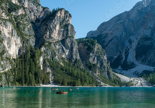 Boats on the blue alpine lake of Pragser Wildsee, Italy