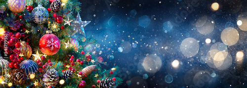 Obraz na płótnie Christmas Tree With Baubles In Blue Night - Ornaments On Fir Branches With Glitt