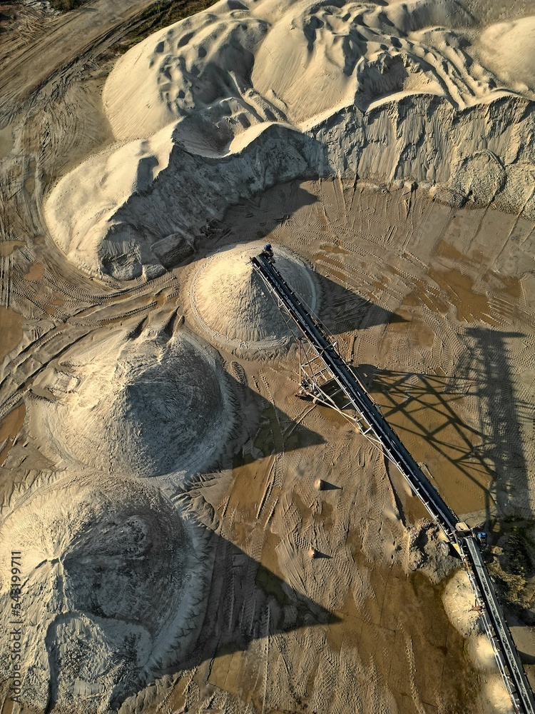 open pit mine and selection of raw materials and minerals extracted from the ground