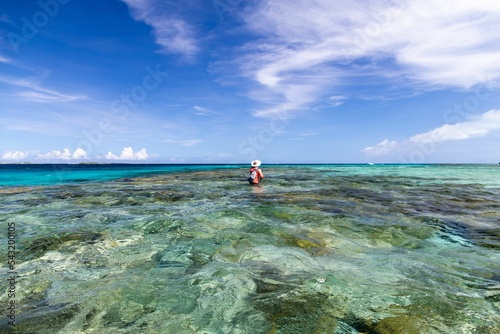 Man fishing in the clear water in White Sand Beach Venezuela Los Roques