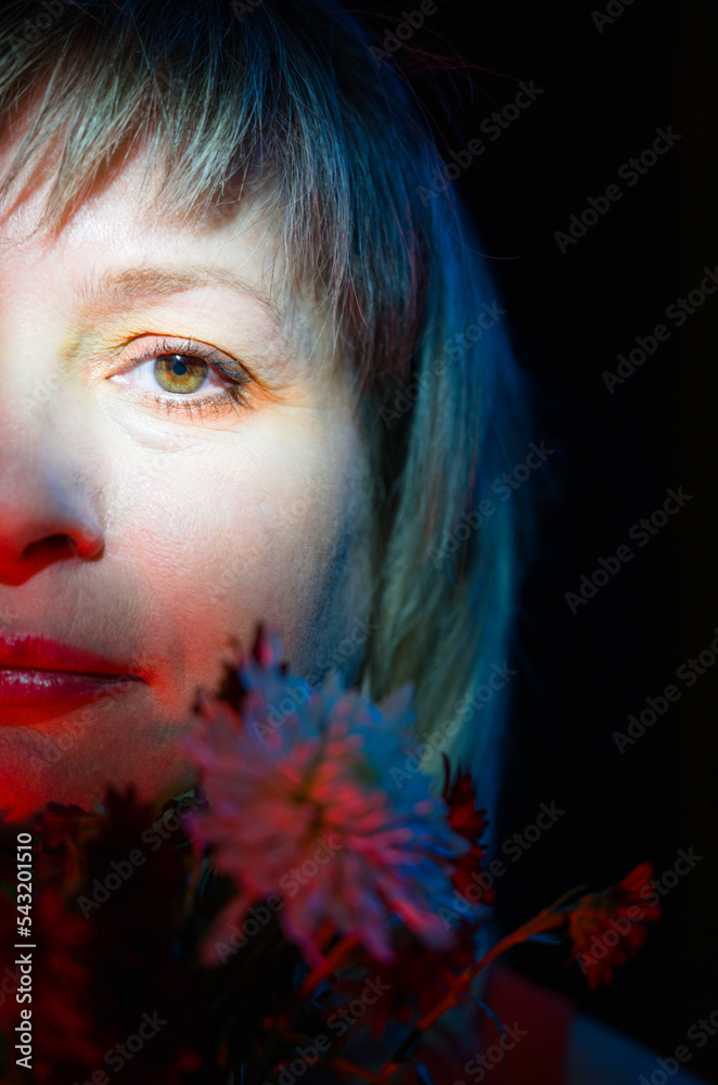 Portrait of a beautiful woman in close-up. Portrait of a woman with flowers. Portrait of a beautiful woman in close-up. Portrait of a woman with flowers.