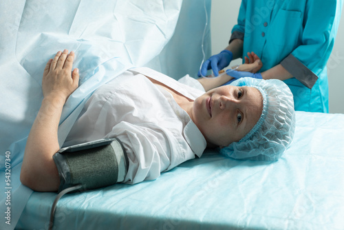 Female patient in operating room at hospital, ready to cesarean section photo