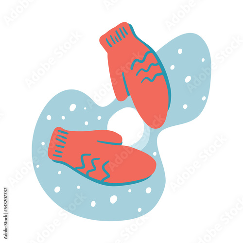 Hands in mittens make a ball of snow on a blue background. Children's winter snowball fight. Snow falls on a clear frosty day. Warm woolen mittens with a cartoon style pattern.
