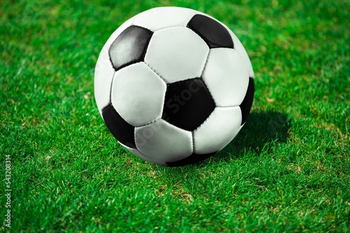 Classic Football Ball on green grass at Stadium © BillionPhotos.com