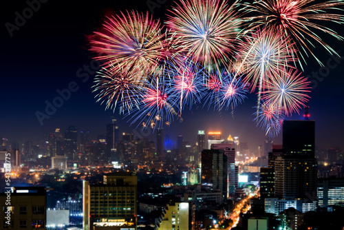 Amazing beautiful colorful fireworks display on celebration night, showing on the city night background
