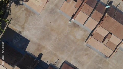 Wallpaper Mural A child rides on roller skates in a skate park and falls. Falls during training in sports. The camera flies from above over the skate park. Top-down view. High quality 4k footage Torontodigital.ca