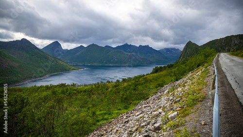 gloomy landscape of the island of senja in northern norway; panorama of the island of senja, the norwegian fjords with their mighty rugged peaks rising out of the sea