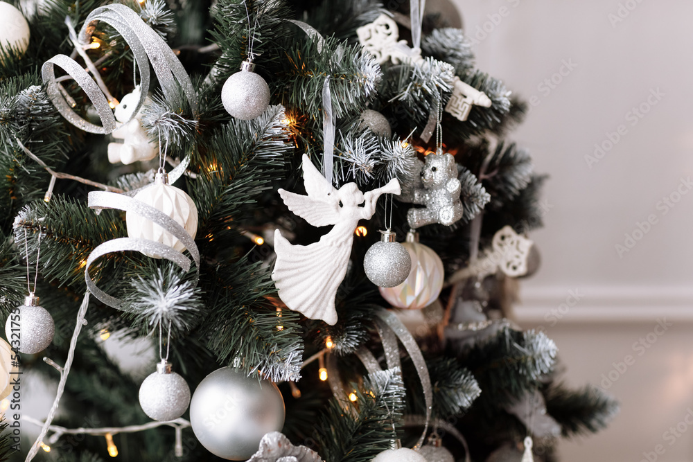 Close-up of Christmas tree decorated with balls, gold and white baubles