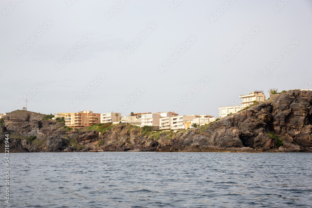 Homes in a touristic Spanish Town by the Mediterranean Sea. Cloudy Sky. Cape Palos, Spain.