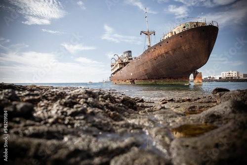 Rusty ship on the sea shore photo