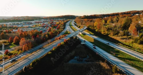 Afternoon aerial, drone, video of NY Route 17 just west of the diverging diamond interchange (DDI), located in Woodbury, NY, with a dolly move pulling away from subject.	 photo