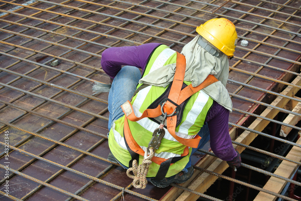 MALACCA, MALAYSIA MARCH 30, 2016 Construction workers fabricating steel reinforcement bar at