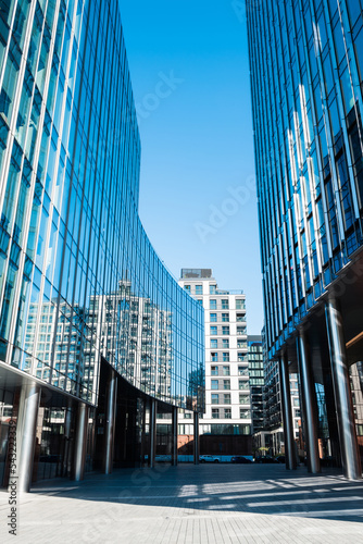 Walkway between modern glass buildings.