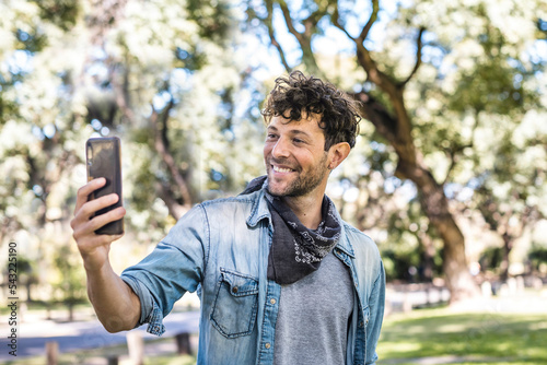 Man taking selfie in park photo