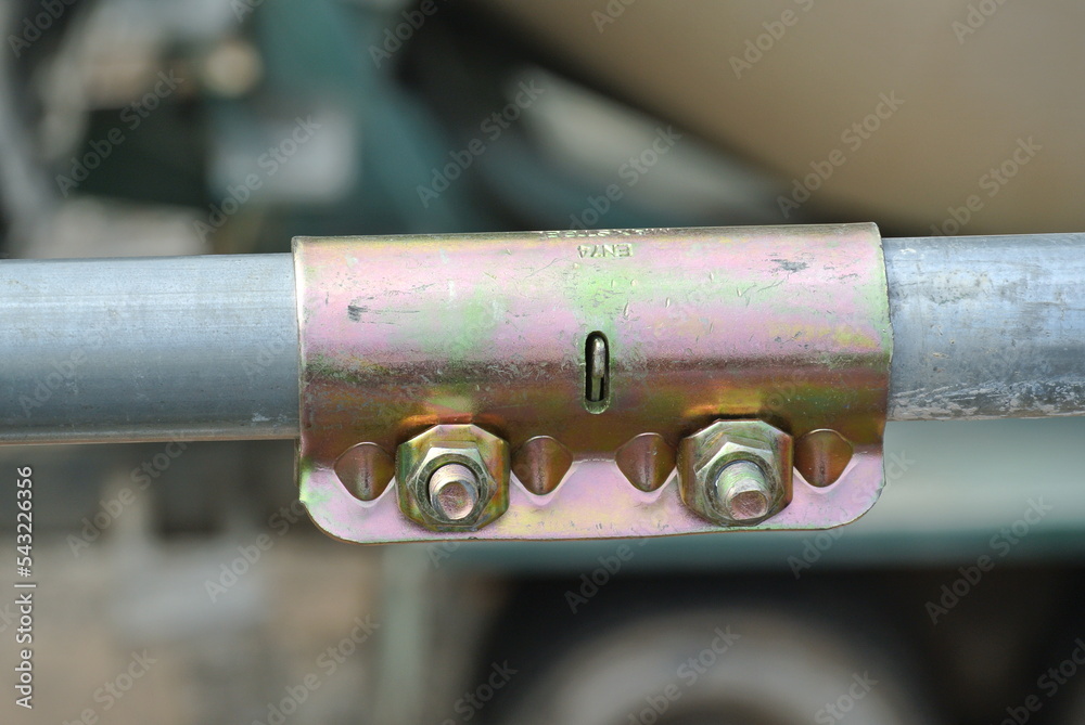 SELANGOR, MALAYSIA -FEBRUARY 26, 2015: Scaffolding connector detail at the construction site. The connector bind two scaffolding or safety pipe together. SELANGOR, MALAYSIA -FEBRUARY 26, 2015: Scaffolding connector detail at the construction site. The connector bind two scaffolding or safety pipe together.