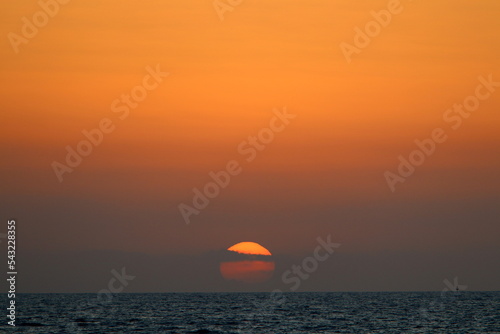 Fototapeta Naklejka Na Ścianę i Meble -  The sun sets below the horizon on the Mediterranean Sea in northern Israel.
