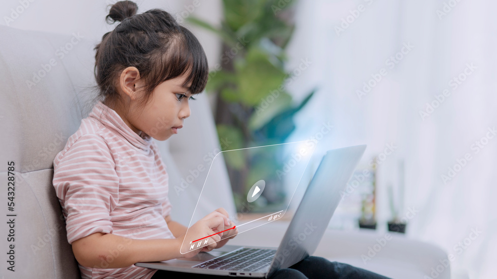 Asian little girl using the laptop. Internet of Things. EdTech. Asian little girl using the laptop. Internet of Things. EdTech.